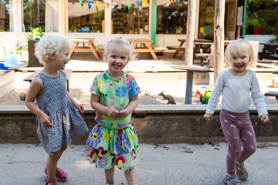 Tre glade børn i sandkassen i Sanderums Grønne Børnehave i Odense